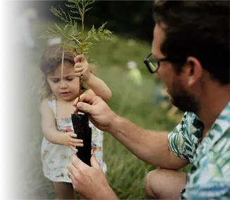 father and daughter planting a tree